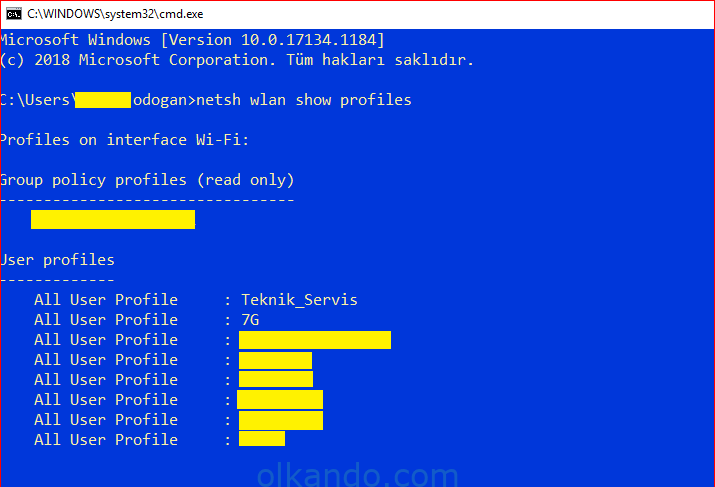 Komut istemi penceresi. netsh wlan show profiles komutu çalıştırılmış; çıktıda kayıtlı kablosuz ağ profilleri All User Profile satırları hâlinde listeleniyor (bir kısmı sarıyla gizlenmiş).